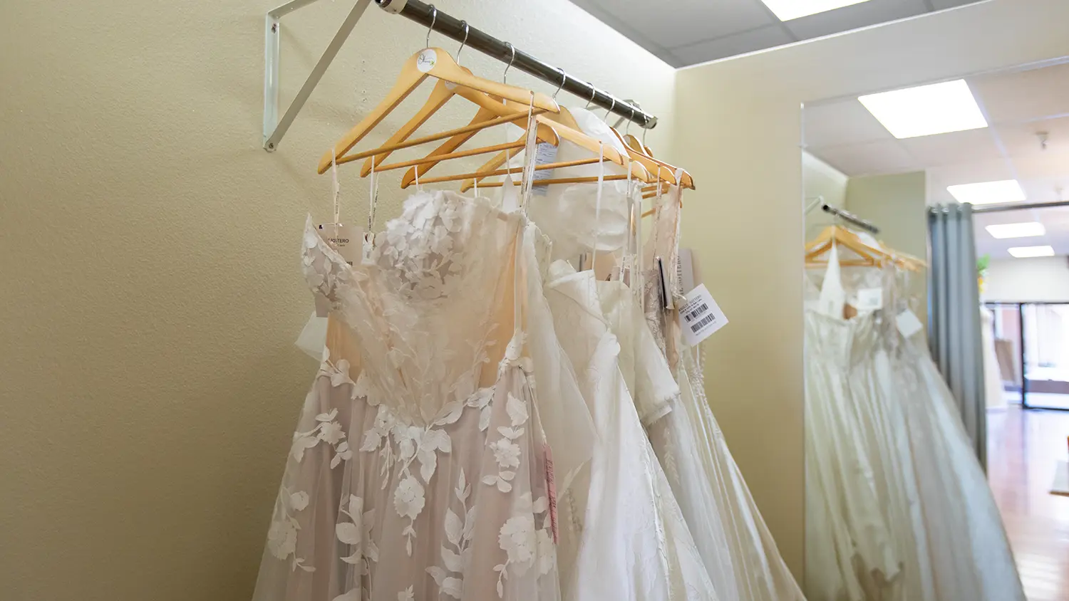 An example of "comfort luxury" wedding gowns hanging up for brides to browse