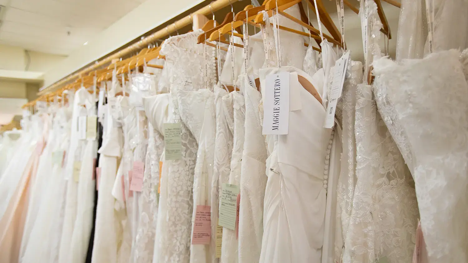 rack of wedding dresses with various neckline options