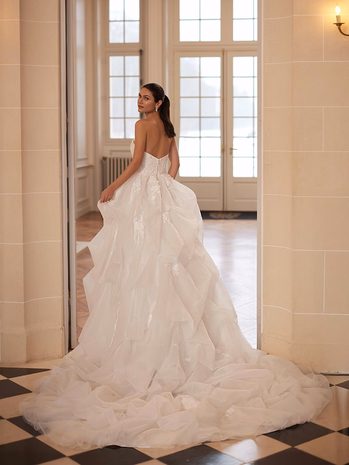 Opaline by Moonlight Couture organza ball gown wedding dress with embroidered lace appliqués, sweetheart neckline, sculptural pickup skirt, V-back, and chapel train.