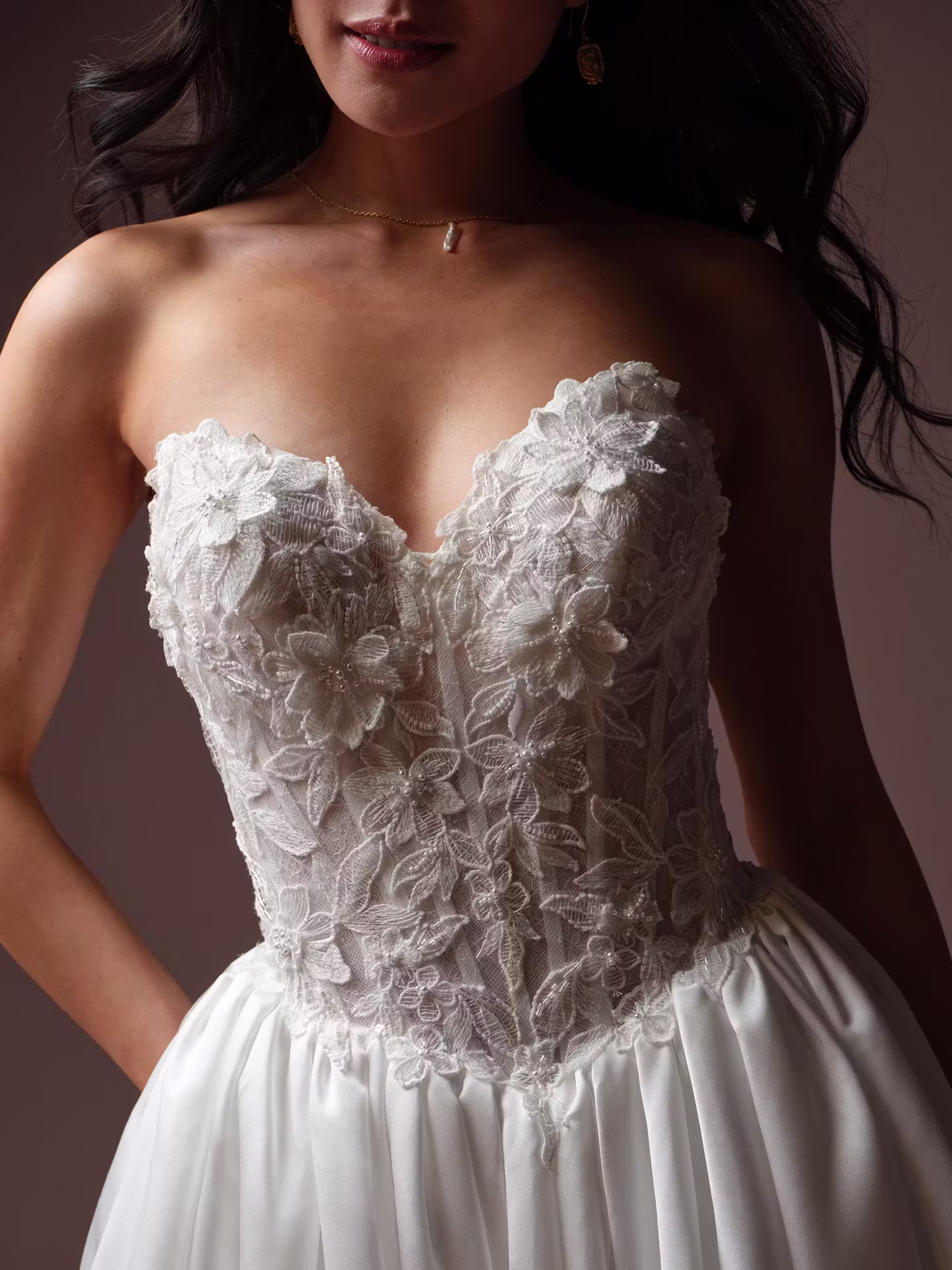 Laurette by Rebecca Ingram satin ball gown wedding dress with Chantilly lace, a sweetheart neckline, illusion lace back, and hidden pockets.