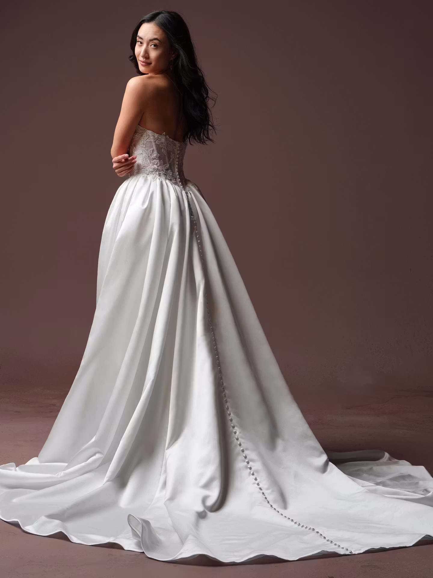 Laurette by Rebecca Ingram satin ball gown wedding dress with Chantilly lace, a sweetheart neckline, illusion lace back, and hidden pockets.