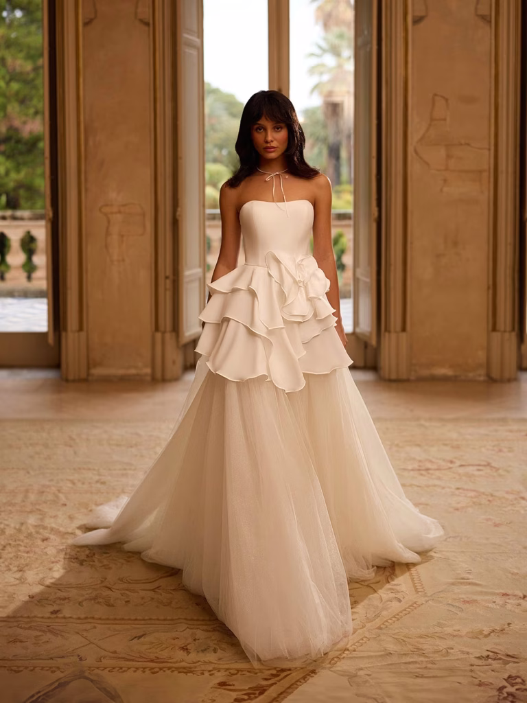 Astraea by Val Stefani convertible crepe mini wedding dress with a sweetheart neckline, tiered skirt and detachable full-length sparkle tulle A-line underskirt.