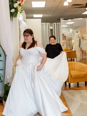 a bride walks to the fitting room in a dress